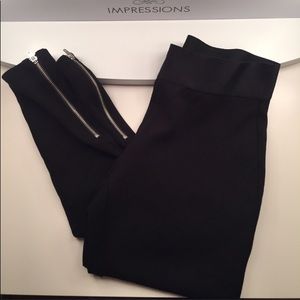 Black Bebe leggings with side zippers on bottom